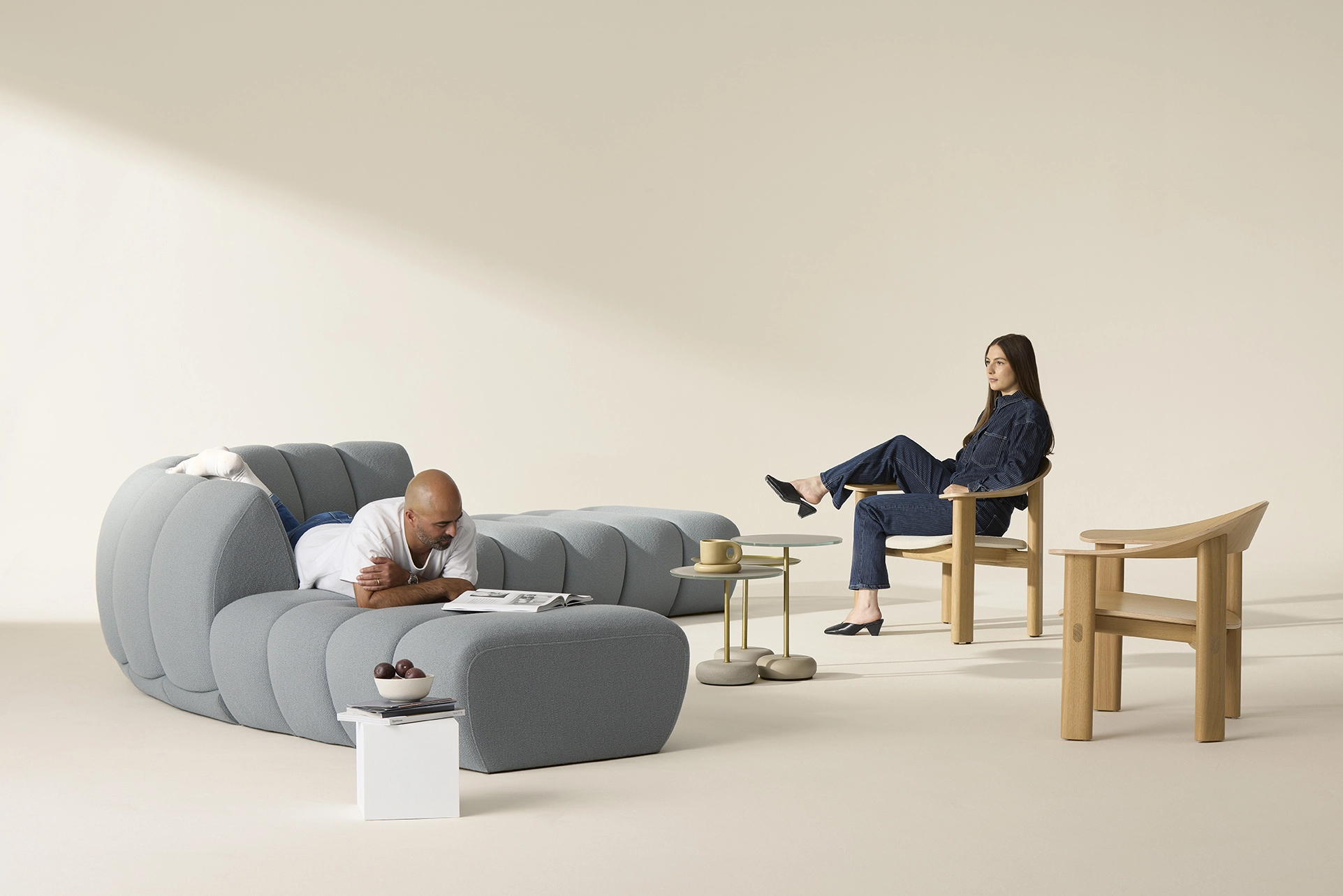 aura curved sofa alonside the curve wooden lounge chair, both by allermuir